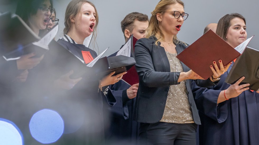 The University of Lodz Choir – women and men singing and holding sheet music 